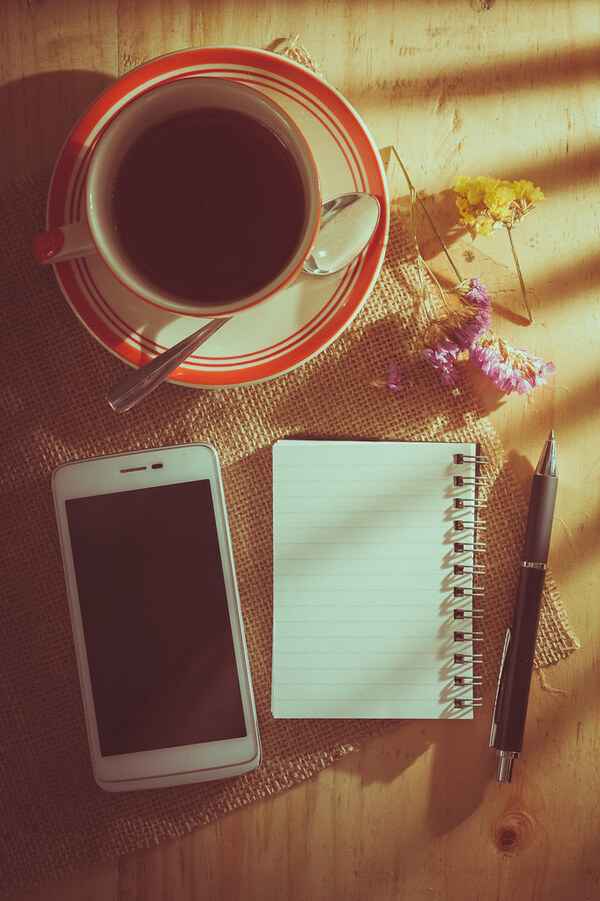 A notebook and pen on a table, suggesting a simple morning note